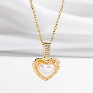 Elegant gold heart pendant necklace featuring a white pearl inlay and sparkling zircon stones
