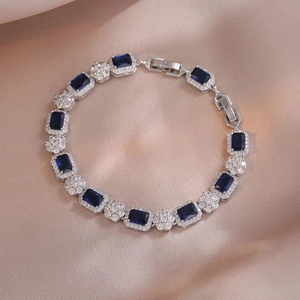 Detalle del brazalete con circón azul corte esmeralda y detalles florales de plata
