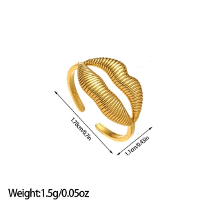 Detail showing lip-shaped open ring dimensions with ribbed texture in gold finish