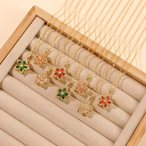 Elegant gold titanium steel necklace featuring a rotating zircon flower pendant in four colors