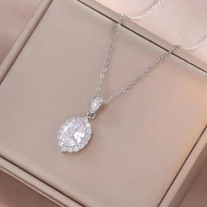 Elegant halo oval cut cubic zirconia pendant necklace with silver chain on velvet