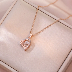 Close-up of rose gold heart pendant with LOVE engraving and sparkling zircon stone