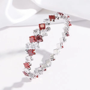 Silver stainless steel bangle featuring double rows of red and white square-cut zircons