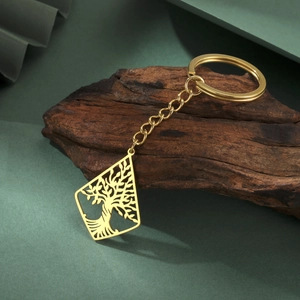 Golden stainless steel tree of life keychain with hollow diamond pendant on wooden branch