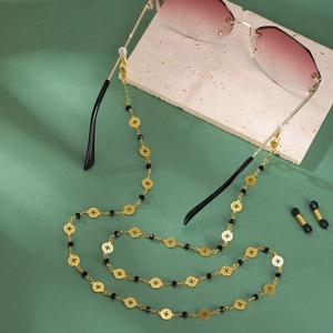 Chaîne de lunettes dorée avec pendentifs en métal ajouré et perles noires