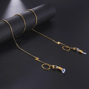 Detail of golden box chain sunglasses strap with lightning bolt pendant and silicone loops