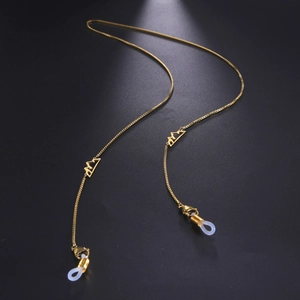 Close-up of golden box chain with hollow mountain charms and silicone loops