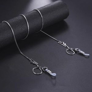 Macro shot of silver box chain eyewear strap with mountain pendant and silicone loops
