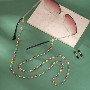 Detail of colorful butterfly eyewear chain with gold links and adjustable rubber loops