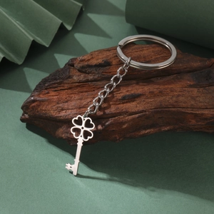 Polished silver stainless steel keychain with hollow four-leaf clover and key pendant charms