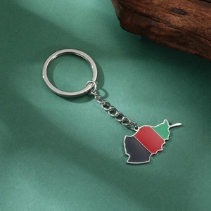 Detail of Afghanistan map keychain with black, red, and green enamel on silver finish