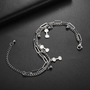 Detail view of double-layer stainless steel bracelet with dumbbell charms and lobster clasp