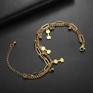 Detail of golden multilayer bracelet featuring dumbbell pendants and adjustable lobster clasp