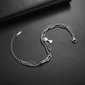 Detailed macro view of silver stainless steel Cuban and paperclip layered chain links