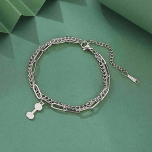Detail of stainless steel double-layer chain with dumbbell pendant and lobster clasp