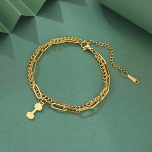 Close-up of golden dual-layer stainless steel bracelet with a dumbbell-shaped pendant