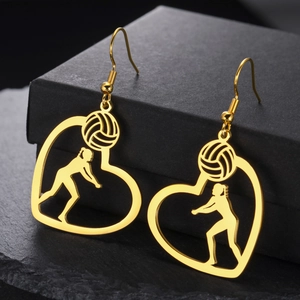 Golden stainless steel volleyball player heart earrings hanging on a black gift box