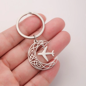 Silver stainless steel crescent moon keychain with celtic pattern and airplane charm