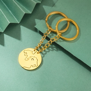 Golden lion head couple keychains with polished stainless steel chain on dark green base