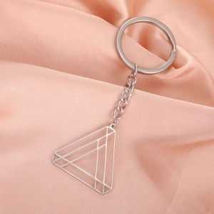 Minimalist geometric hollow triangle stainless steel keychain on pink silk background