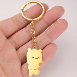 Detailed view of a golden stainless steel bear pendant on a chain keychain