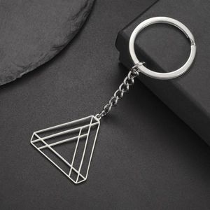 Close-up of silver geometric hollow triangle keychain made of polished stainless steel