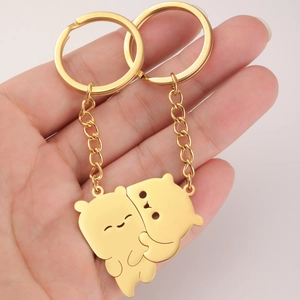 Detailed view of two golden interlocking bear pendants for a couple's keychain