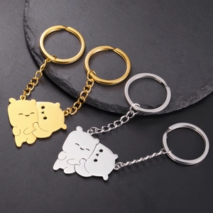 Macro shot of interlocking bear charms in gold and silver finish stainless steel