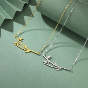 Bamboo pendant necklaces in gold and silver finish displayed on creative green backdrops