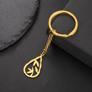 Detailed view of a gold bamboo-textured water drop pendant with hollow leaf pattern and chain