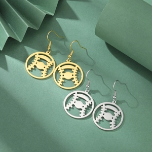 Detailed close-up of hollow baseball-themed stainless steel earrings in gold and silver