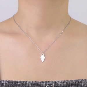 Minimalist stainless steel necklace featuring a silver jellyfish shell pendant on a model