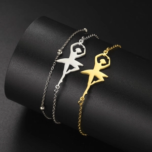 Polished stainless steel ballerina bracelets in gold and silver on a display stand