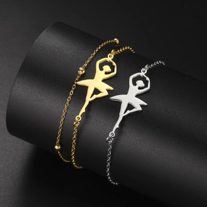 Detailed close-up of ballerina charms on bead chains in gold and silver finish