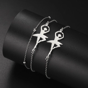 Macro view of polished ballerina pendant on beaded stainless steel bracelet with glossy finish