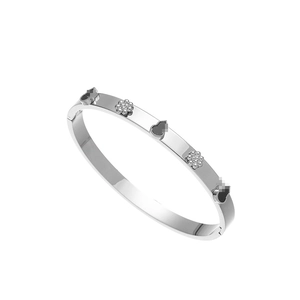 Detailed close-up of a silver stainless steel bracelet featuring black enamel clover motifs