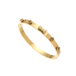 Close-up of golden stainless steel bracelet with ornate 3D bow and rose flower details