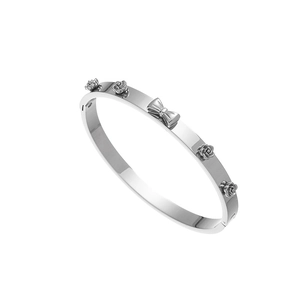 Detail view of silver stainless steel bangle with 3D rose flowers and bowknot design