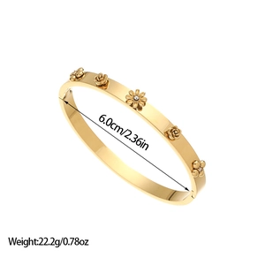 Detailed view of gold stainless steel bangle with flower charms and size dimensions