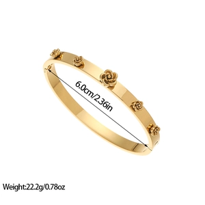 Vintage gold plated stainless steel bangle featuring five relief roses with side clasp