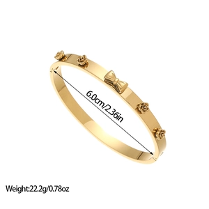 Vintage gold plated stainless steel bangle featuring 3D rose and bow floral details