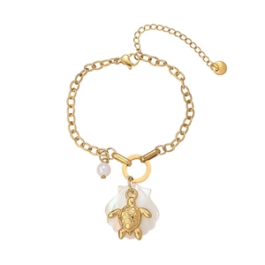 Macro view of 18K gold plated sea turtle, white shell, and pearl charm details