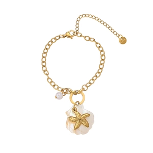 Macro shot of 18K gold plated starfish shell pendant on stainless steel bracelet