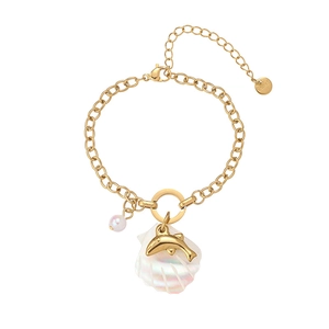 Detail of 18K gold plated stainless steel bracelet with shell, dolphin, and pearl charms