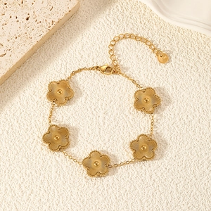 Macro detail of gold flower bracelet with sunburst texture and beaded edge design