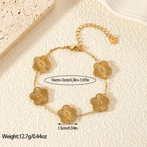 Detailed view of gold five-petal flower charms with dimension labels and measurements