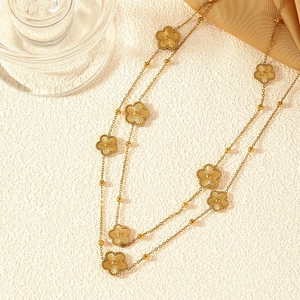 Elegant gold double-layered sweater necklace featuring textured five-petal flower pendants
