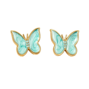 Detailed view of mint green enamel butterfly charms with 18k gold vacuum plating finish