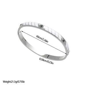 Detail showing dimensions of silver steel bangle with green zircons and white enamel