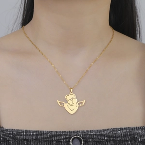 Close-up of gold angel mother and baby pendant necklace worn on neck